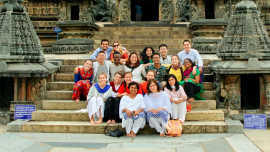 Students and scholars sitting on steps in India in summer 2018