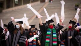 Newly minted graduates from the College of Veterinary Medicine wave their long gloves to celebrate on Saturday.