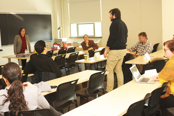 Professor leads workshop in classroom with several attendees