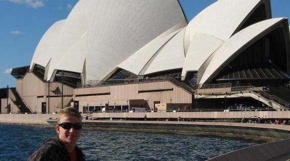 Student sitting in front of Sydney Opera House