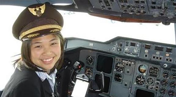 Co-op student sitting in the cockpit of a UPS plane