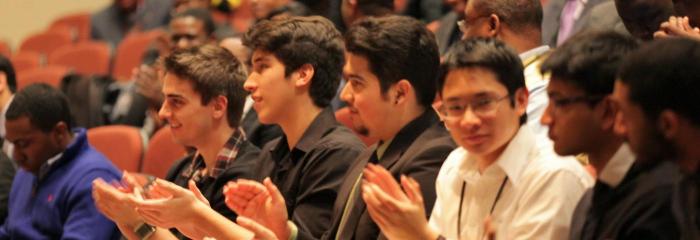 Students clapping at symposium
