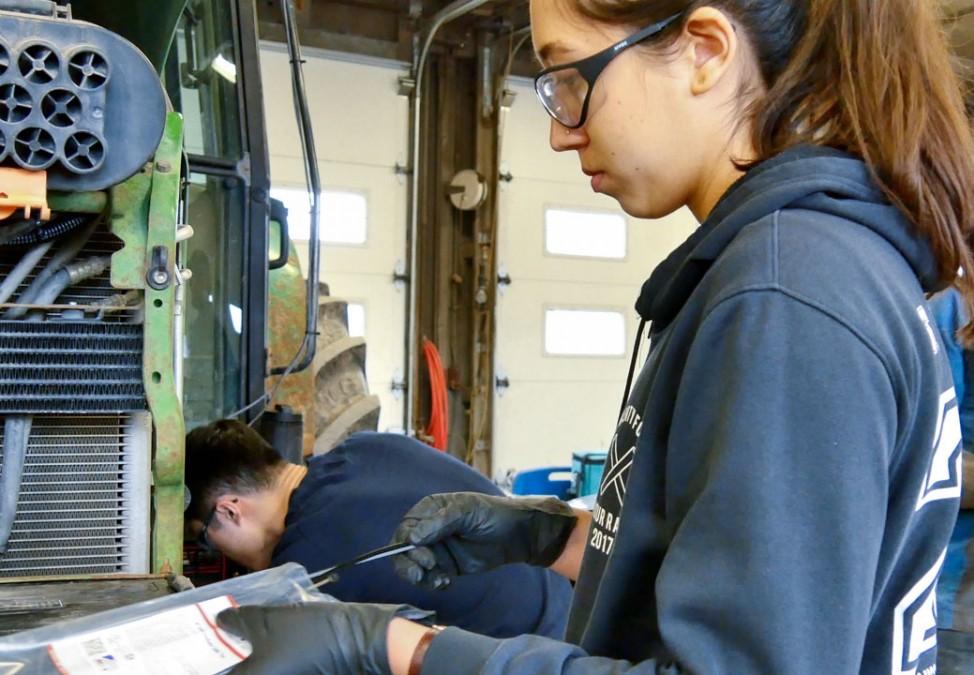 Engineering student works on converting a tractor to take biodiesel. 