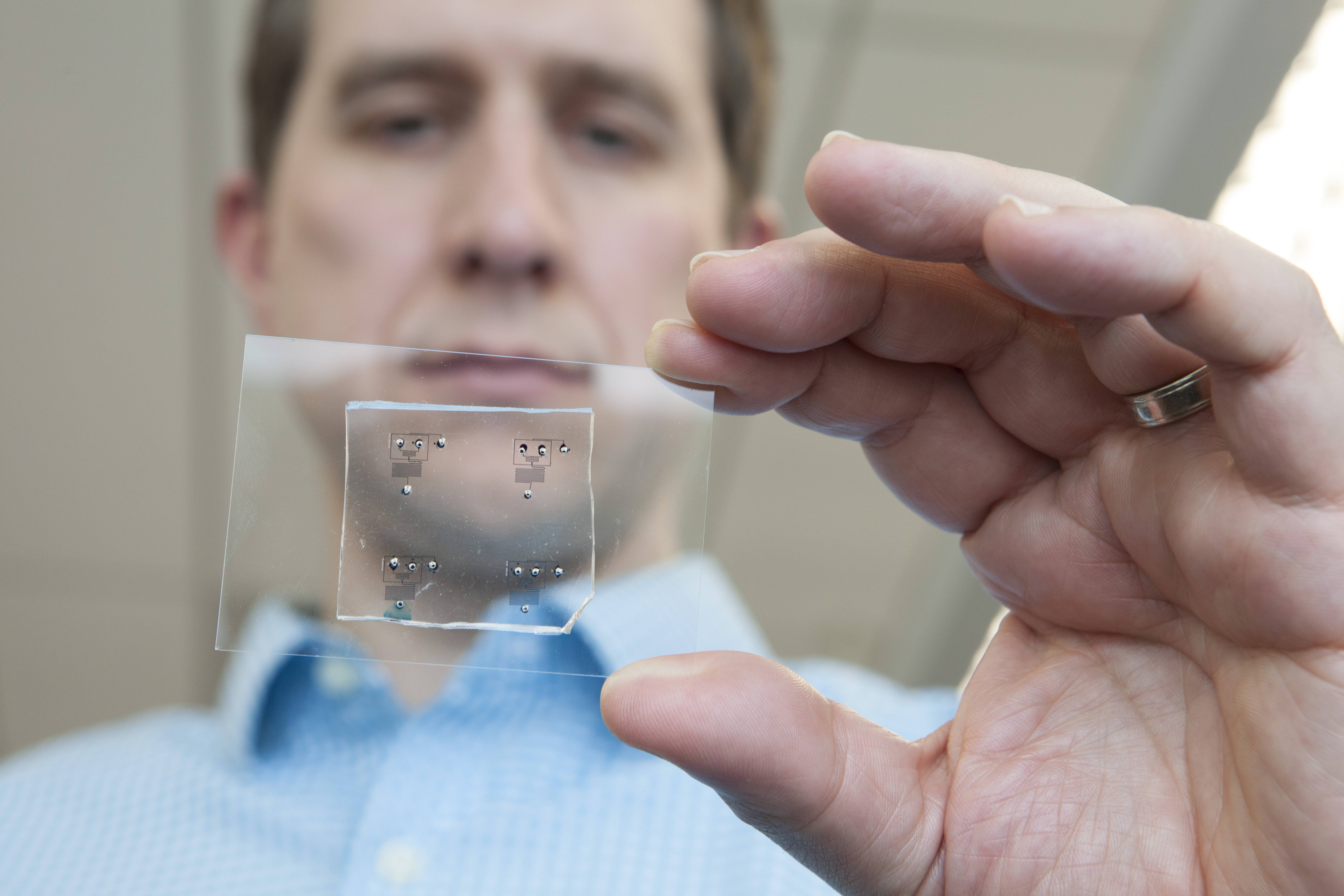 Cosgrove holds microfluidic device