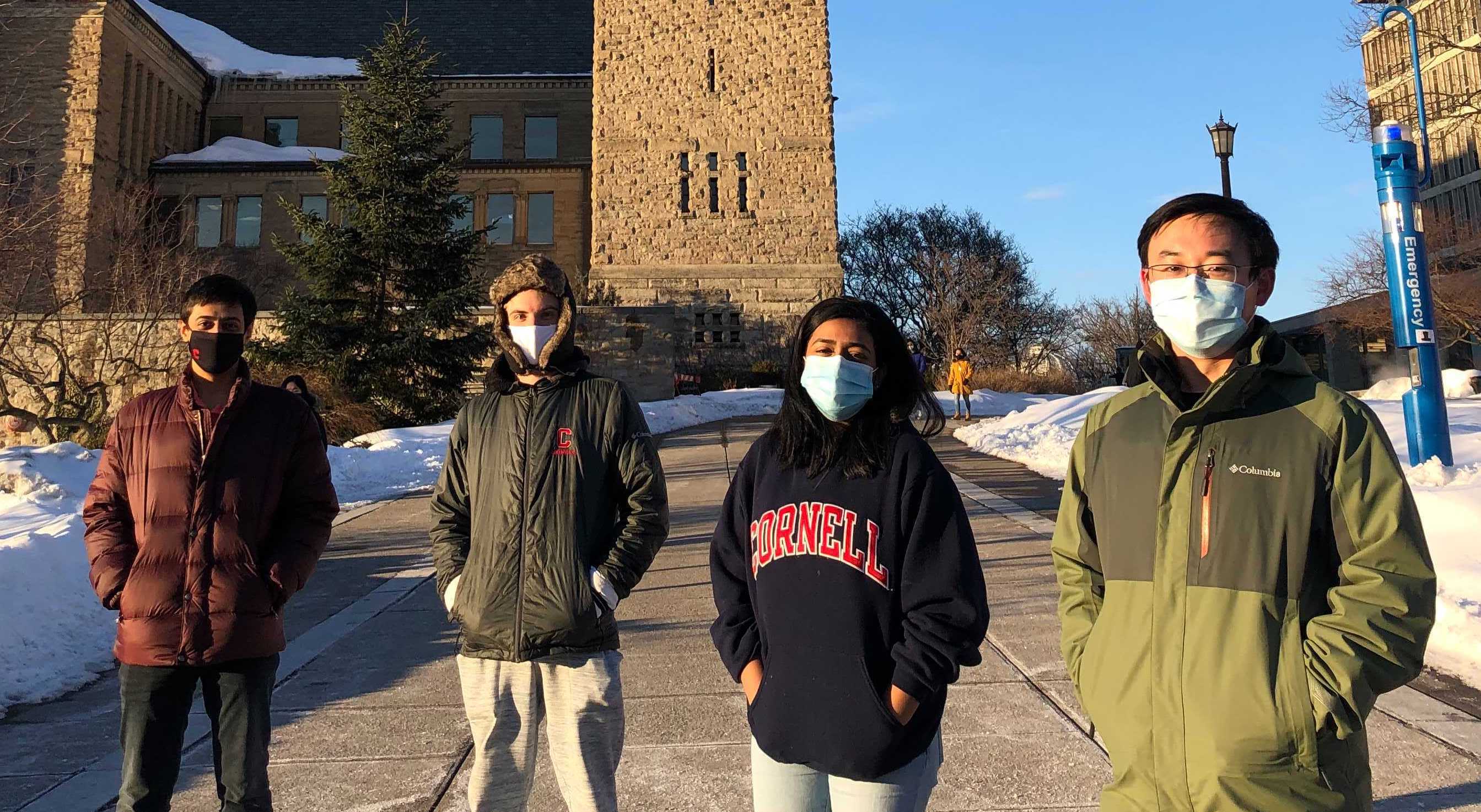 four students standing outside