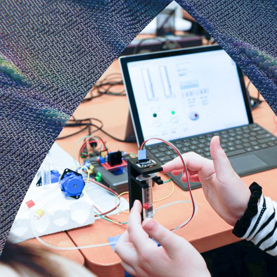 A student works with controllers and computer software