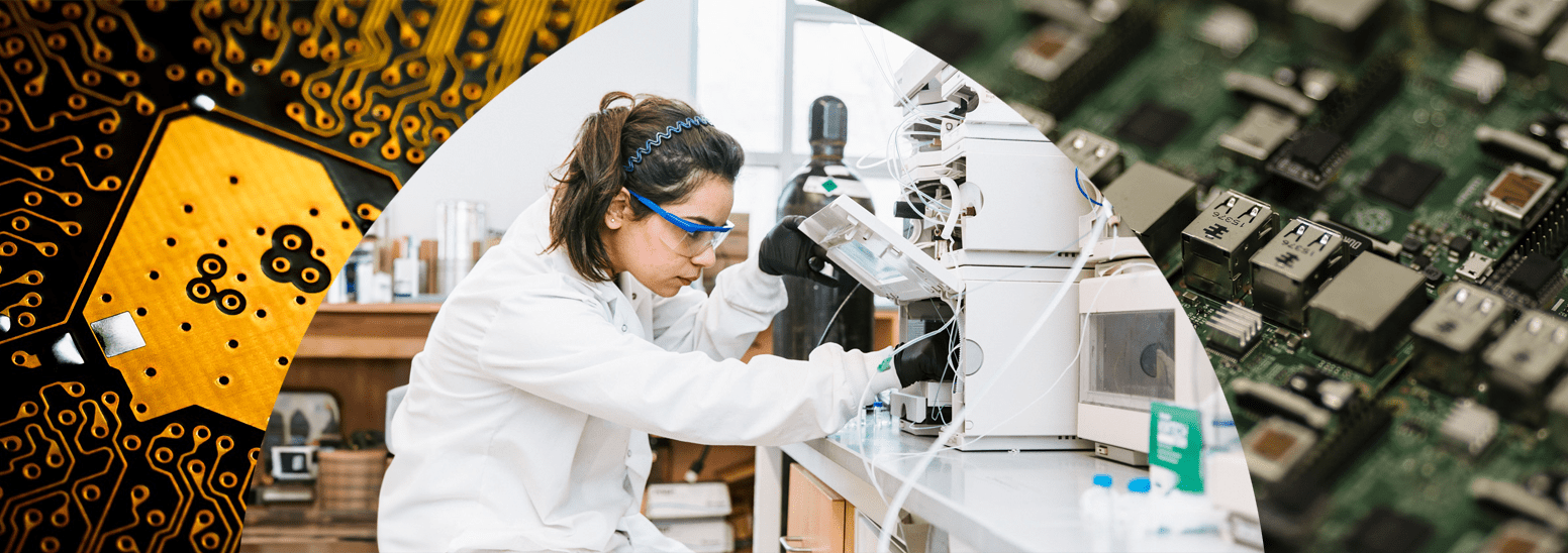 Researchers in lab coats and gloves work in lab with test tubes and protective glass panel