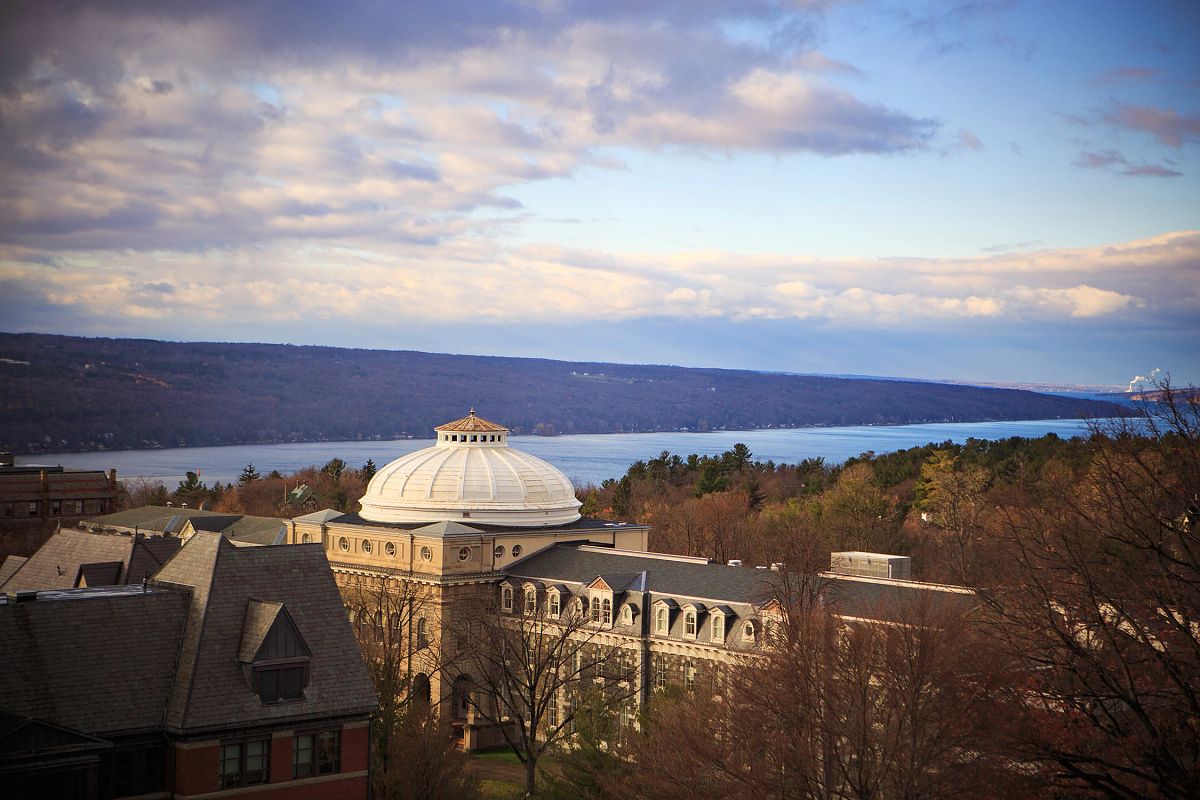 Arial view of Sibley Hall during fall with Cayuga Lake in background