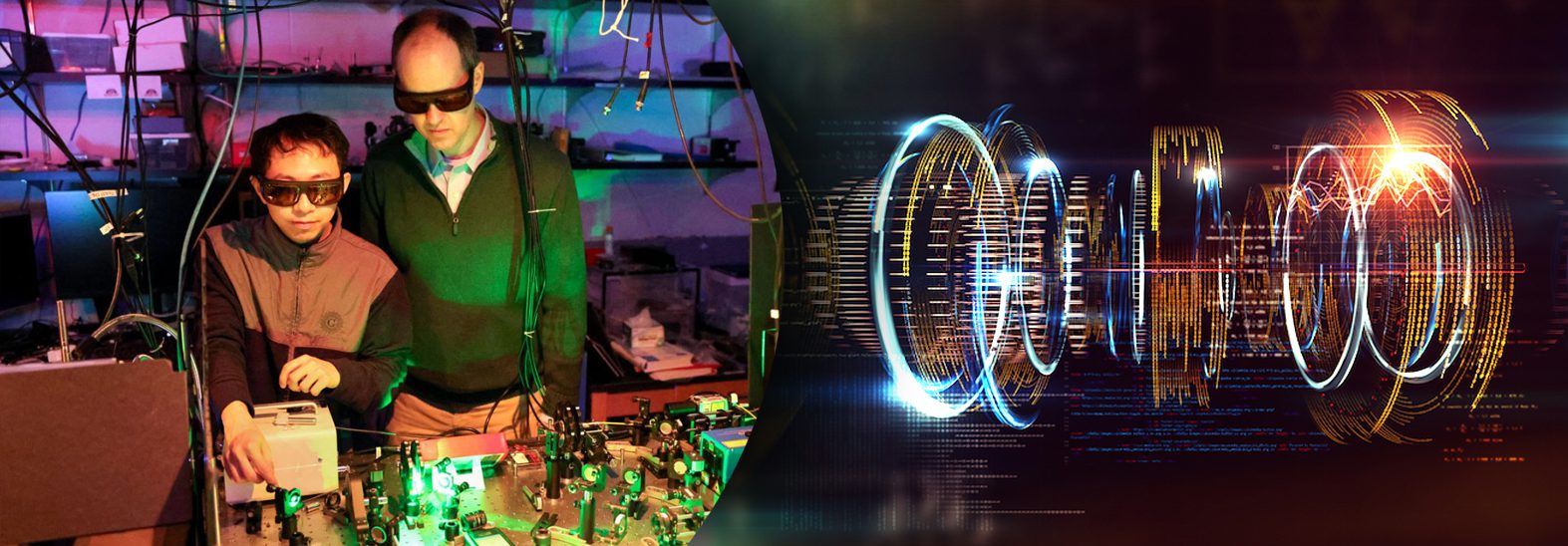 A professor works with a student in a dark lab with a tabletop laser setup