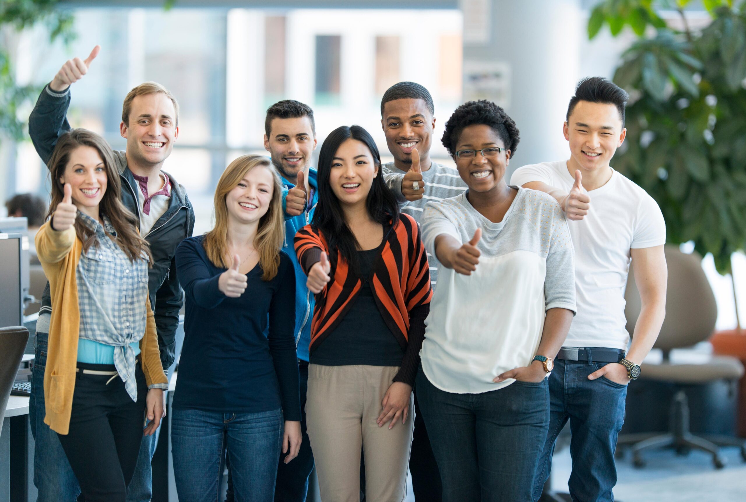 Students stand together with arms around each other and smiling
