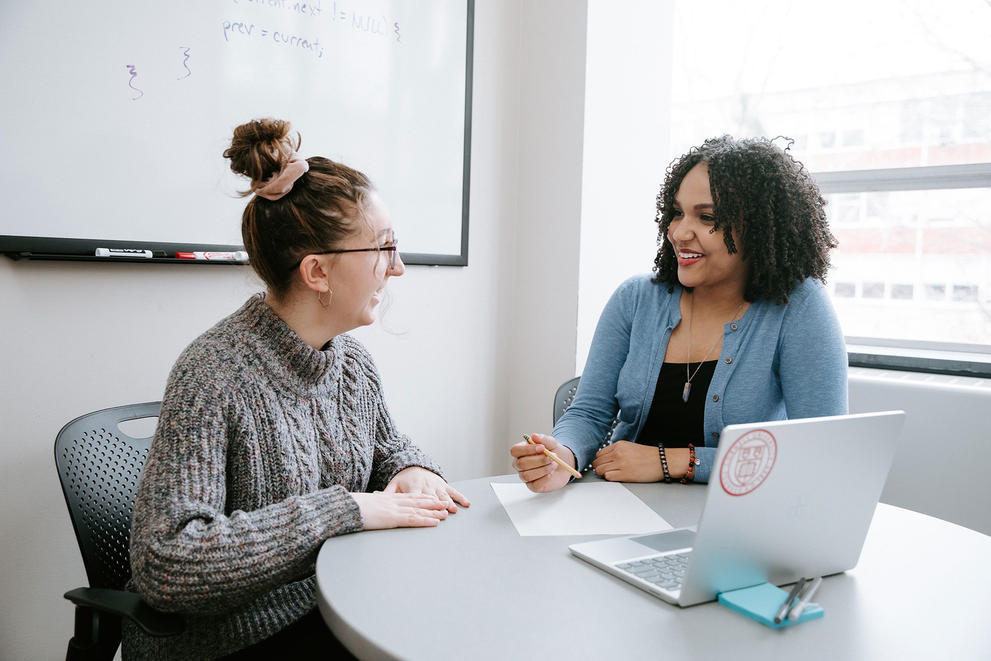 Career Center peer advisor speaks with student at table