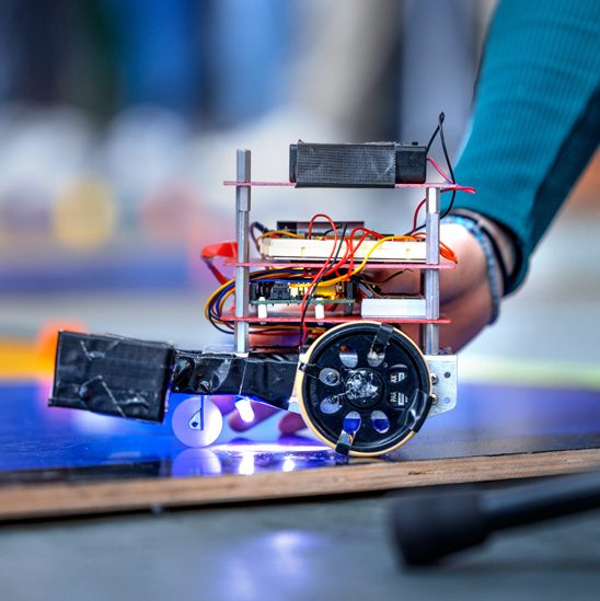 robot with wheels and blue LED lights