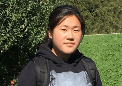 Female student outside in a green area