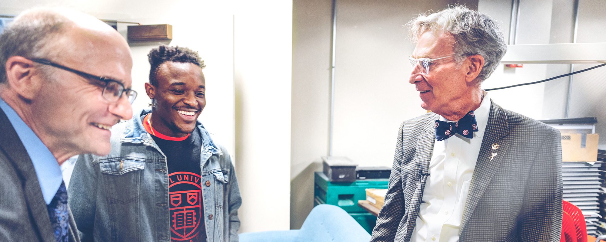 Bill Nye laughing with two other people