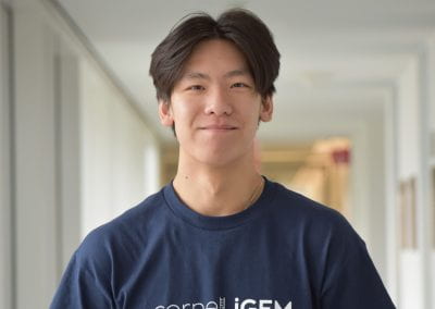 Male student smiling inside a building
