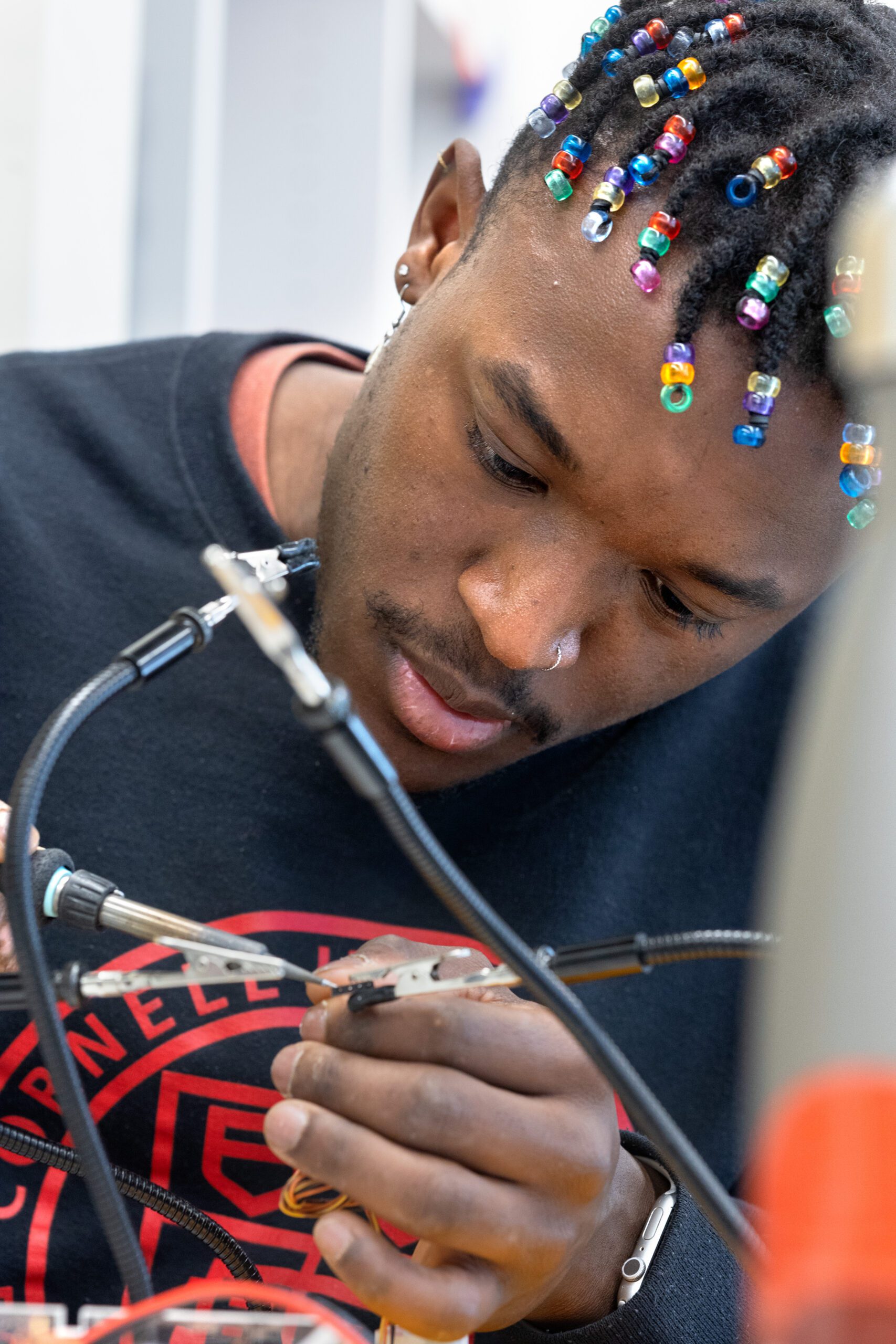Smith Charles, ’23, works on a project in the Cornell Maker’s Lab in Phillips Hall.