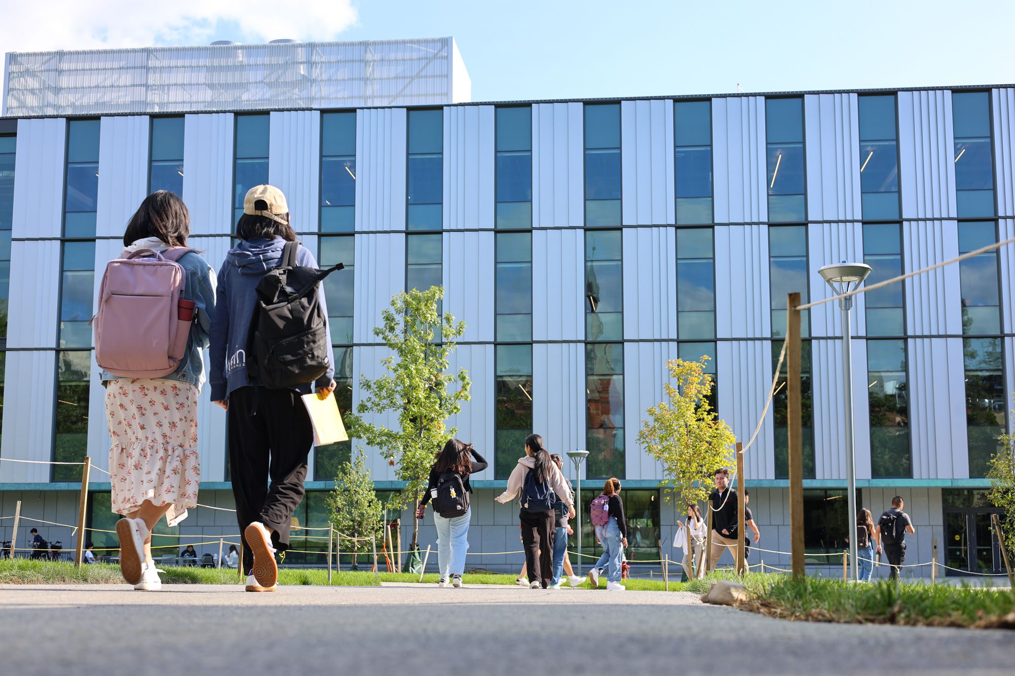Students walk across the Engineering Quad in front of Tang Hall