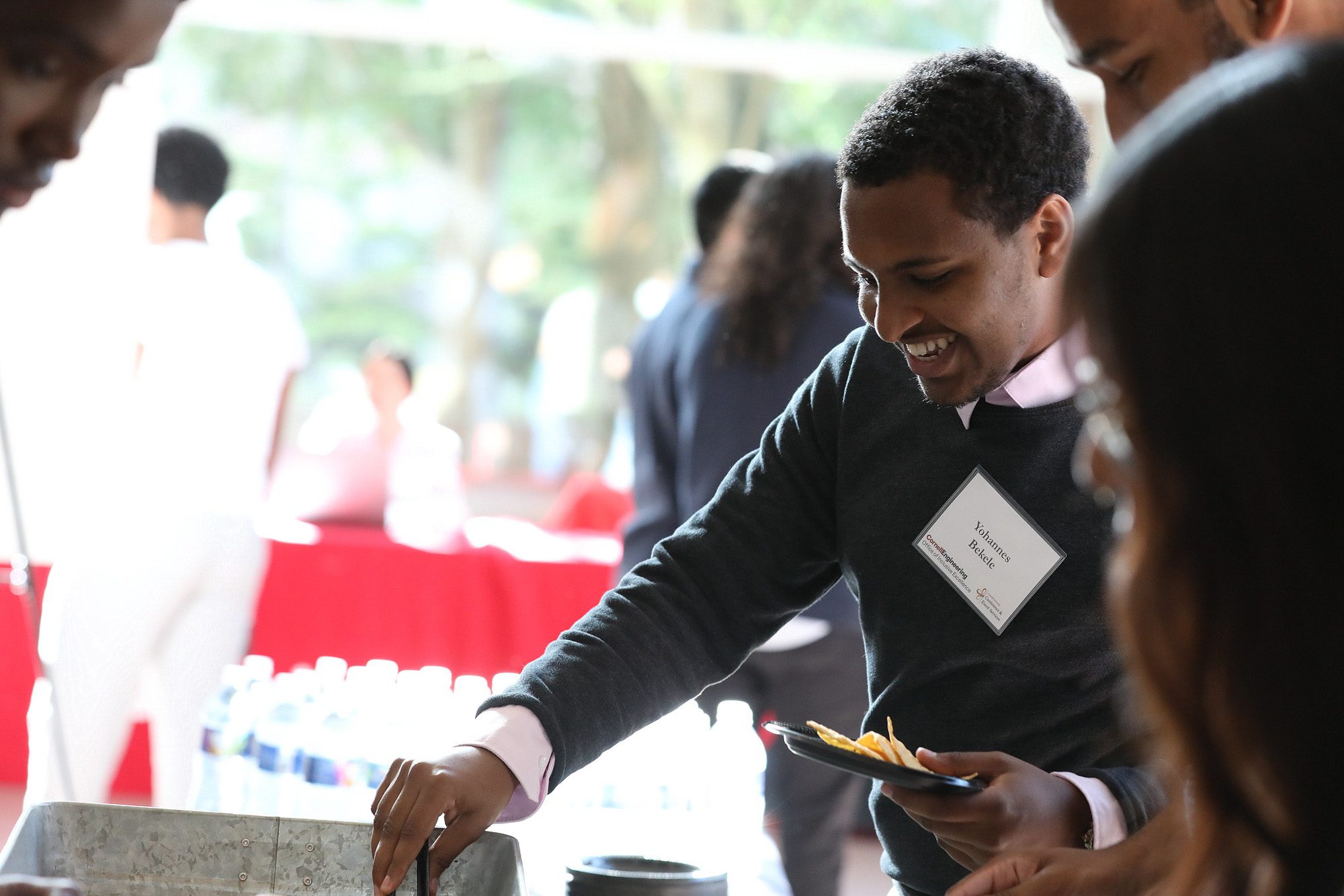 Students talk while getting food at a buffet