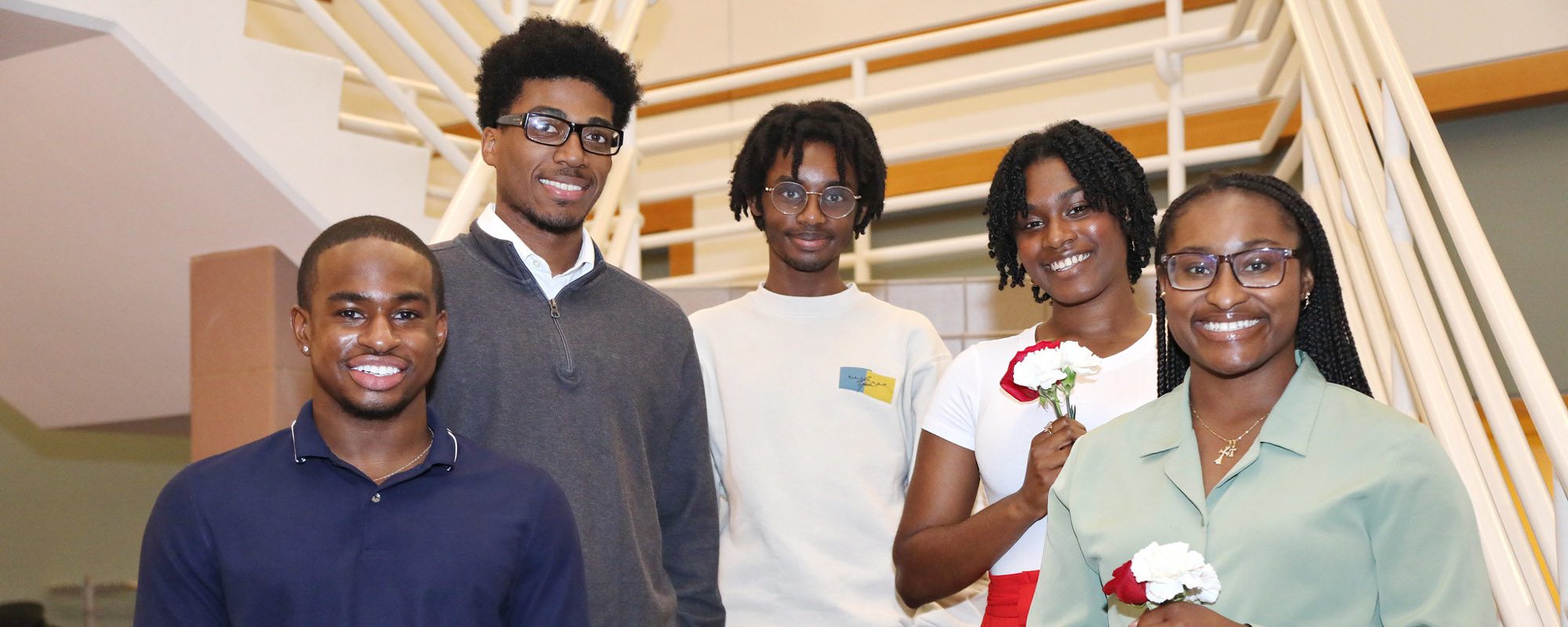 5 students smile together for a photo