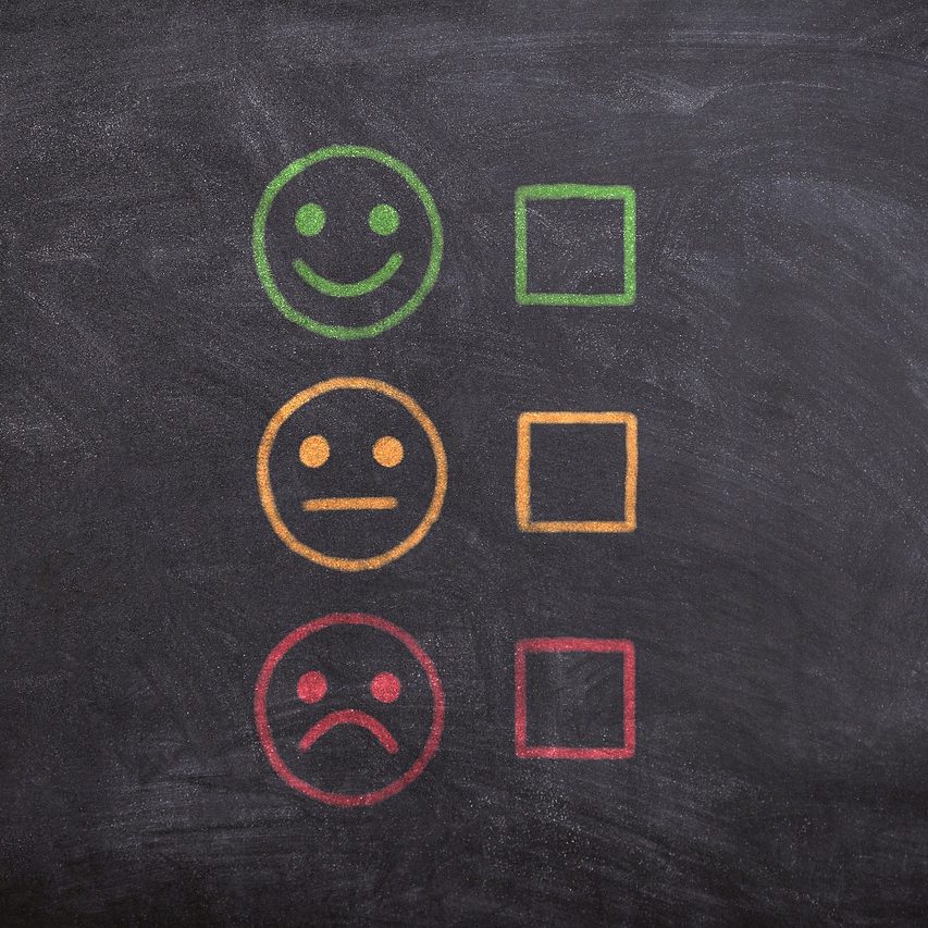 Three circles show happy, neutral, and sad faces with a check box next to each