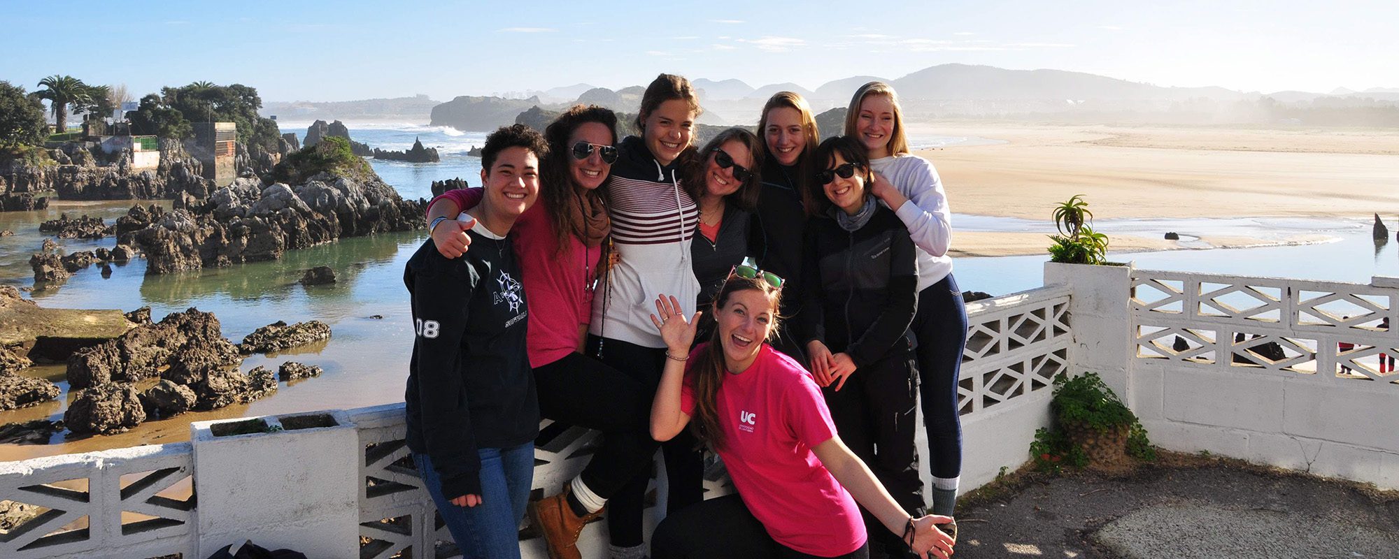 Students smile together by the water during a study abroad in Cantabri, Spain